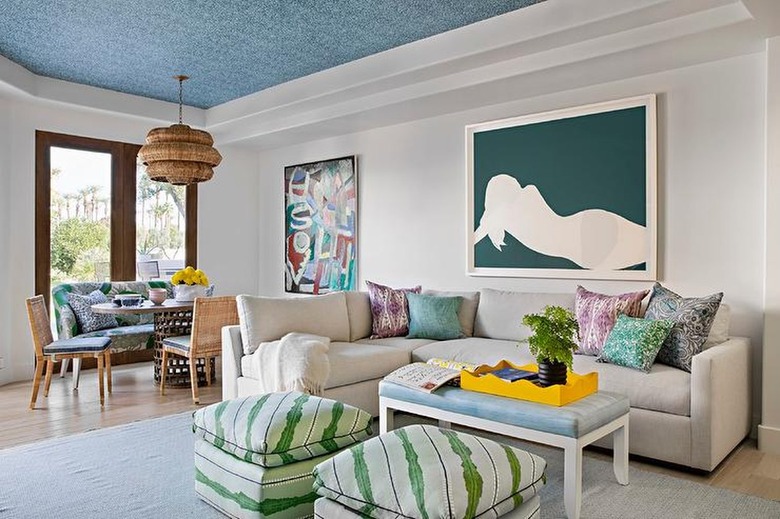 living room with neutral walls and blue ceiling