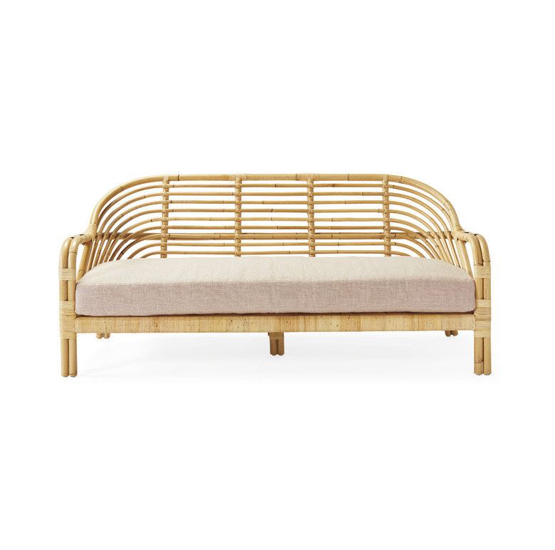 blush room decor with rattan sofa and pink cushion by Serena & Lily