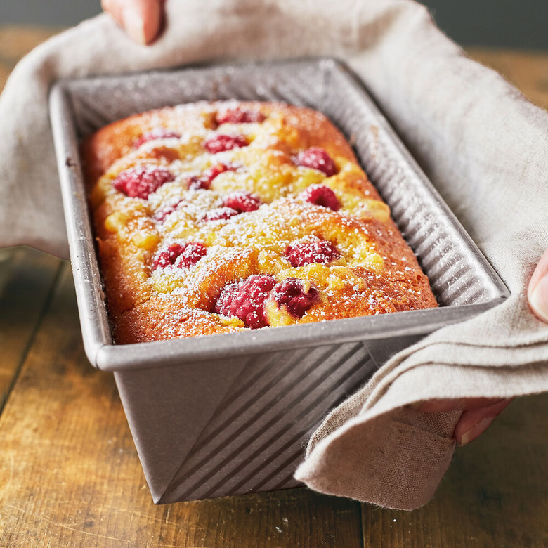 person holding bread loaf in pan