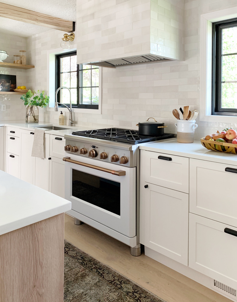 kitchen with white and brush bronze Cafe stove