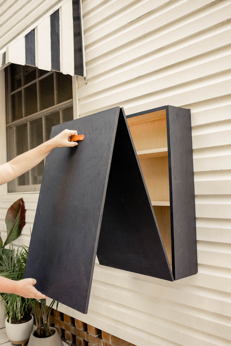 Pulling Murphy bar down from the wall with leather handle
