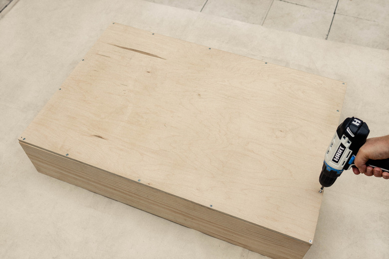 Attaching plywood sheet to back of cabinet with HART drill