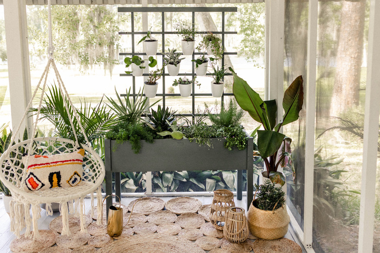 DIY vertical plant wall trellis on boho patio with hammock