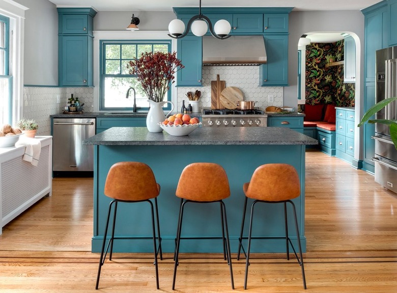 teal kitchen with natural wood floors