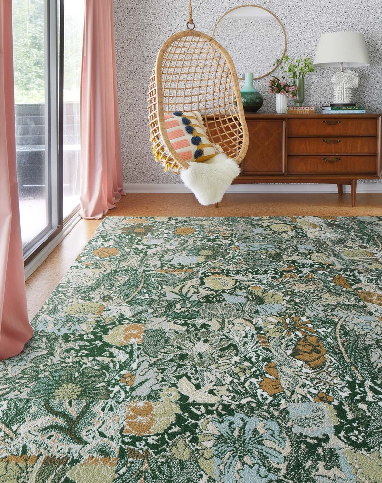 room with gray walls and green patterned carpet tiles