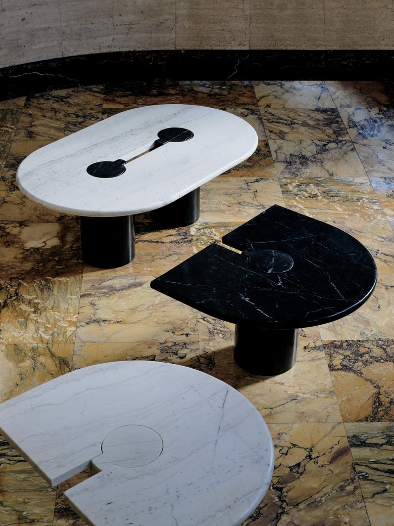 A solid white Tornado marble top sits atop a richly veined Marquina black marble base