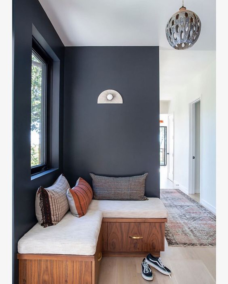 charcoal color window seat with built-in bench and throw pillows