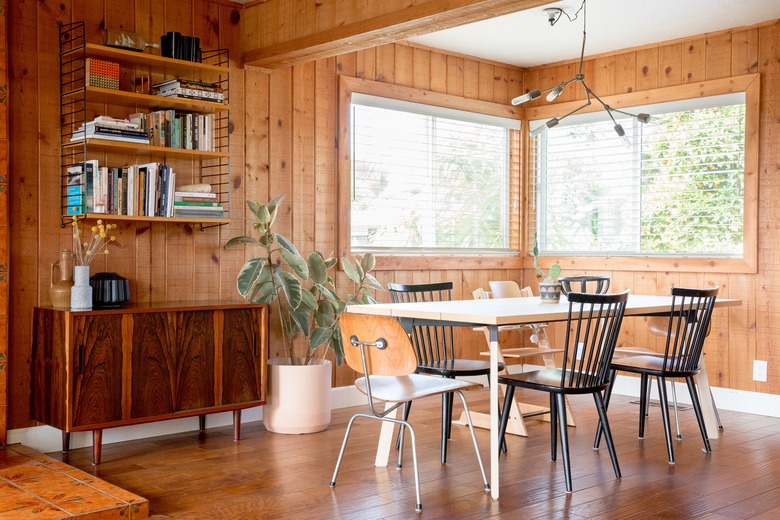 dining room with wood plank walls and hardwood floors