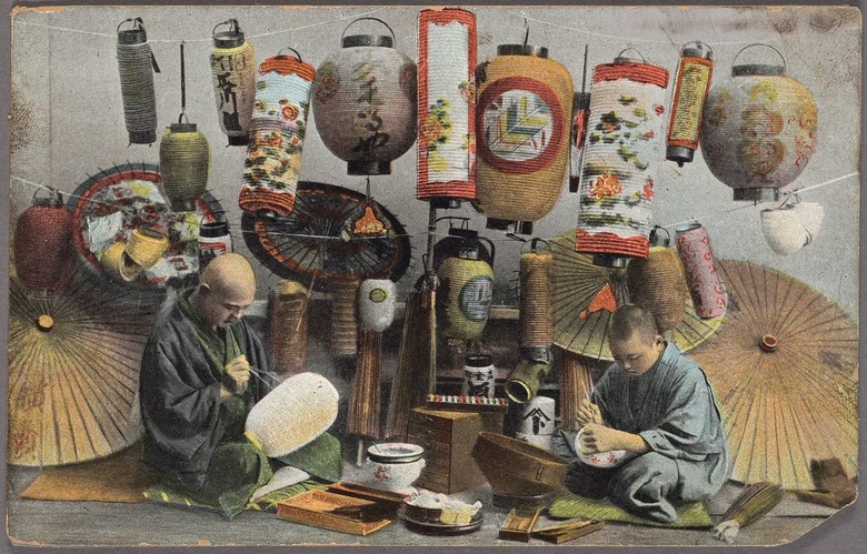 A colorized postcard of Japanese lantern painters working on lanterns.
