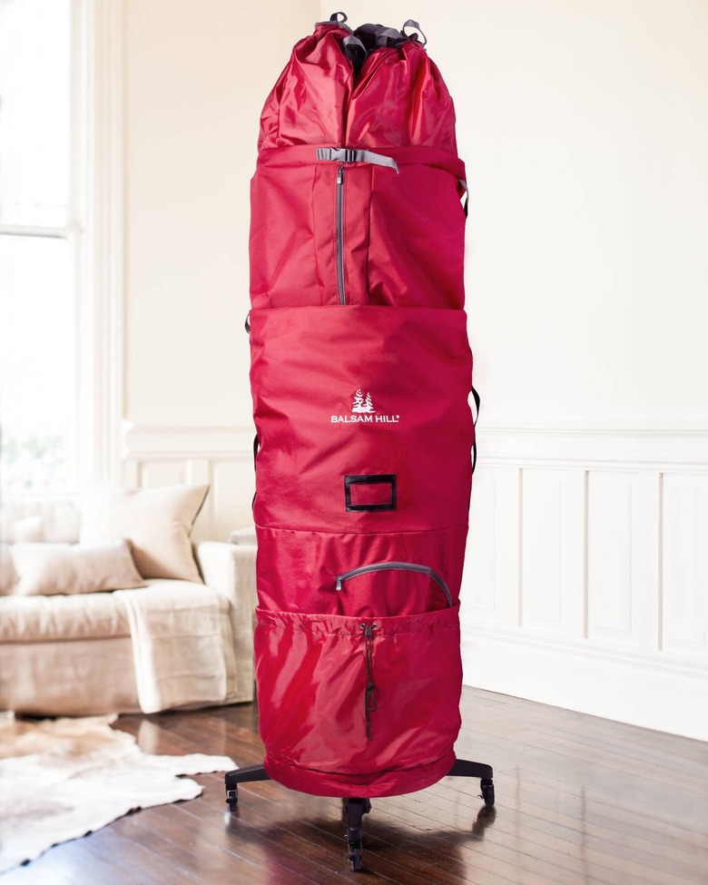 Red rolling Christmas tree storage bag in living room
