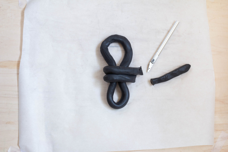 Cutting excess clay off knot