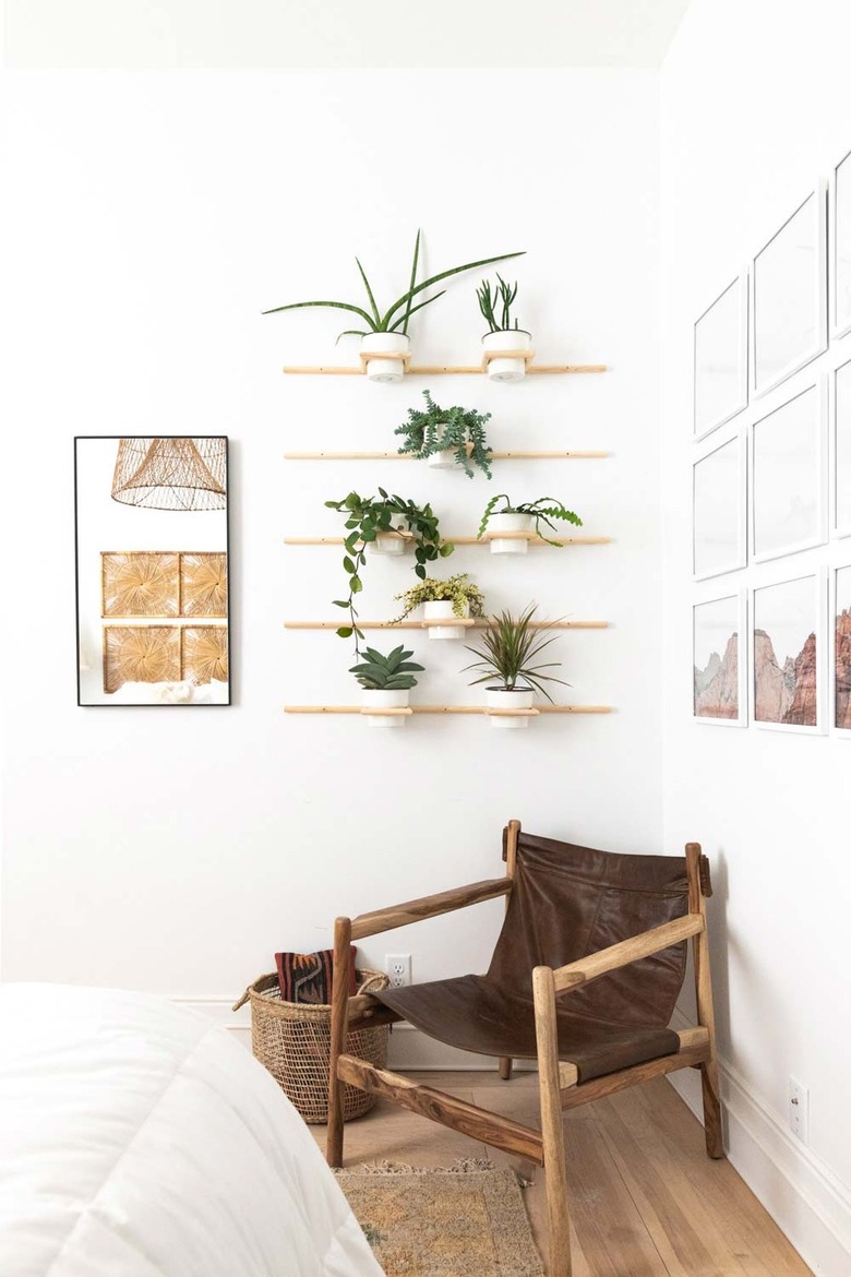 boho bedroom with wall of potted plants
