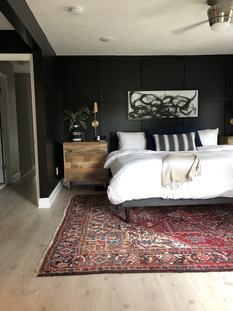 black bedroom with black and white abstract painting