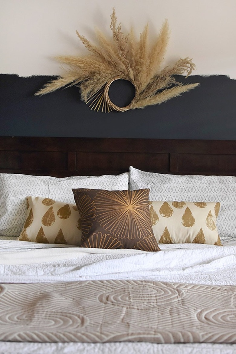 dried pampas grass wreath above bed