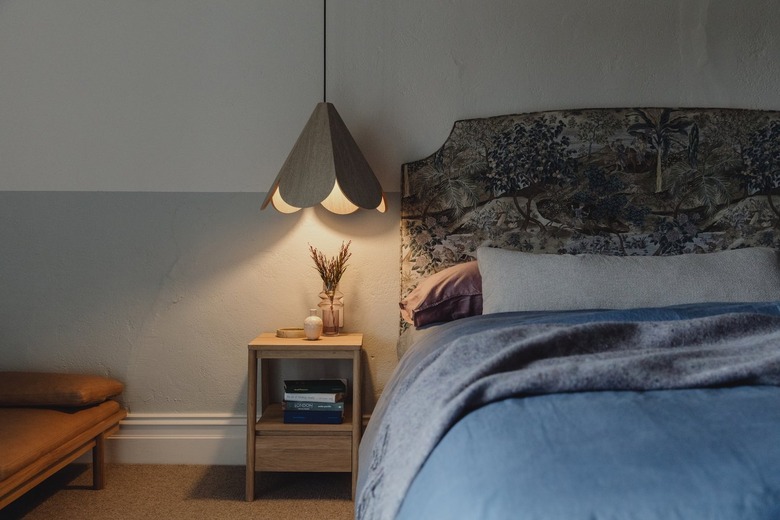 bedroom with custom upholstered headboard and blue bedding