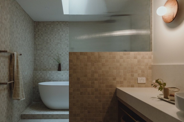bathroom with combined freestanding tub and shower alongside vanity area