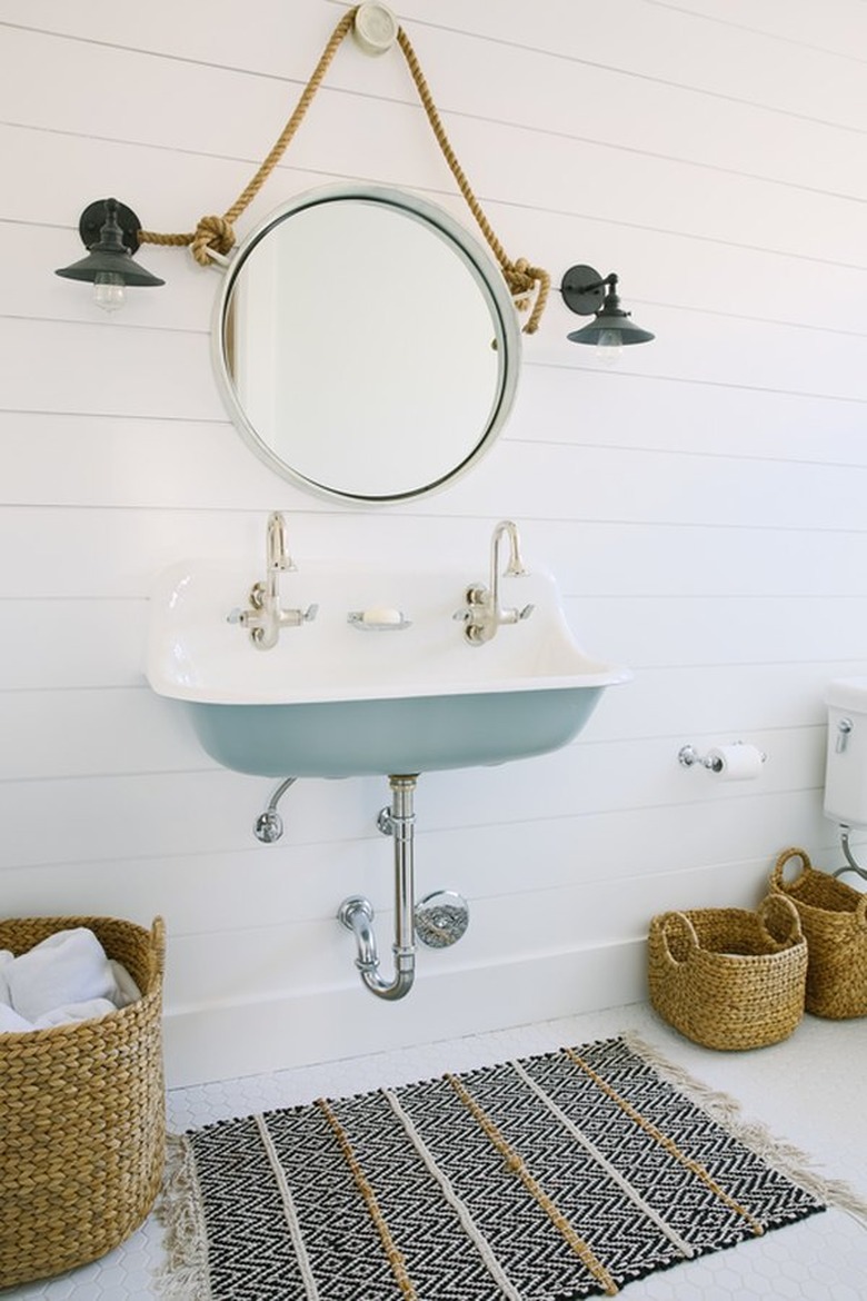 coastal bathroom with white and light blue trough sink