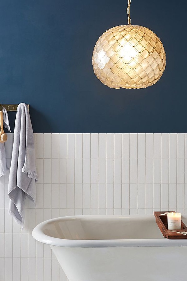 Capiz coastal bathroom lighting idea in white and navy blue bathroom
