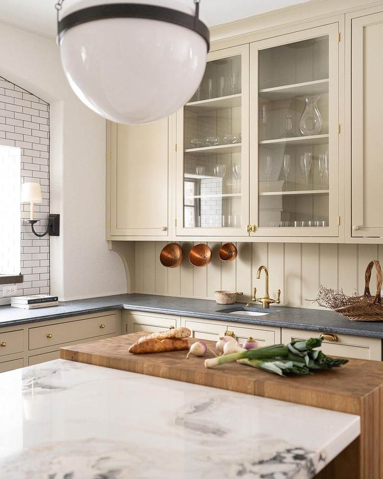 cream kitchen with glass-front cabinet