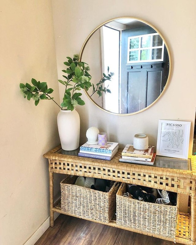 entryway console with gold circular wall mirror