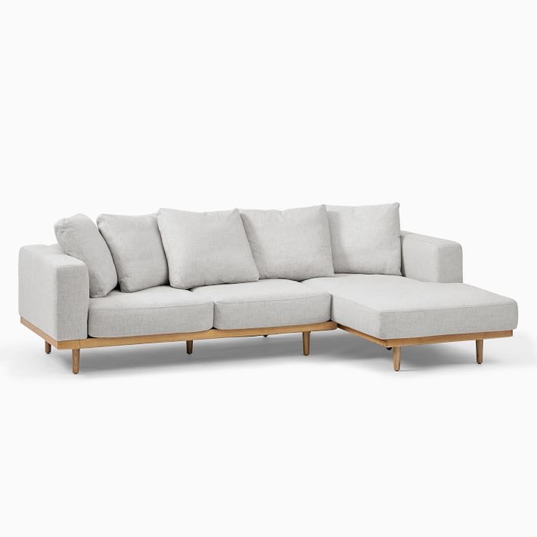 modern coastal sofa with wood base by West Elm