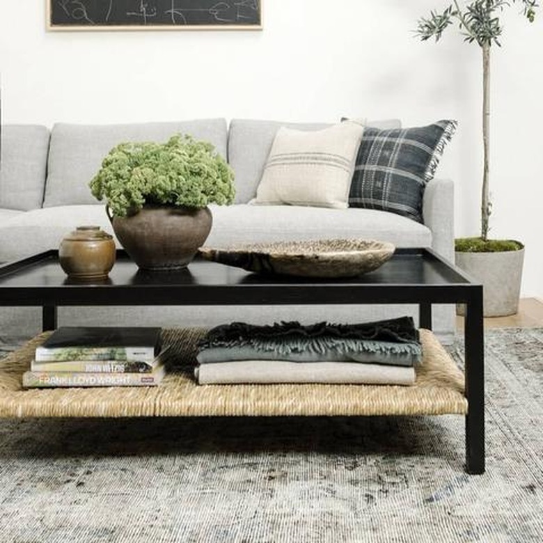 ebonized wood and rushed coffee table with storage