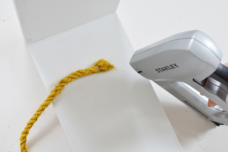 Sisal rope attached to white wood with stapler