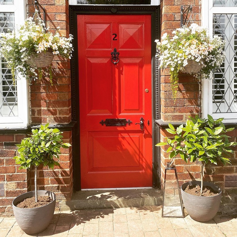 brick exterior with glossy red door