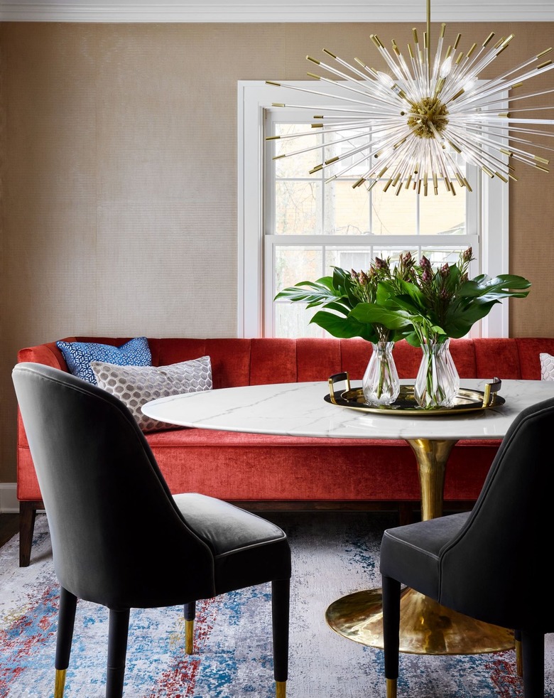 Champagne-hued walls with burgundy couch