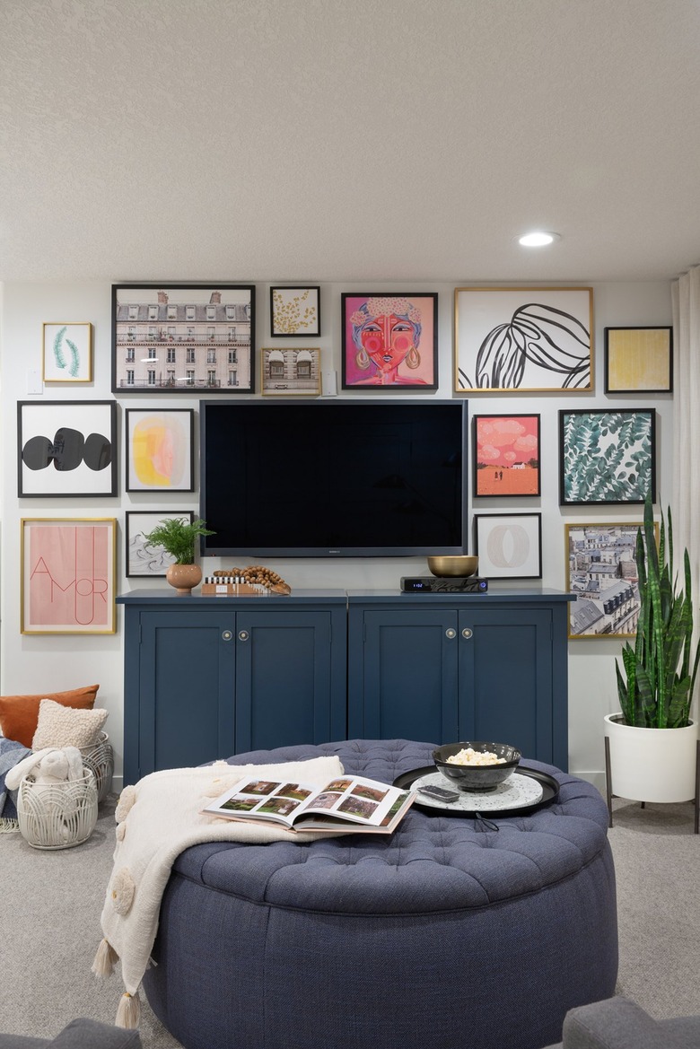 Blue cabinet and ottoman/table in white room with light gray carpeting