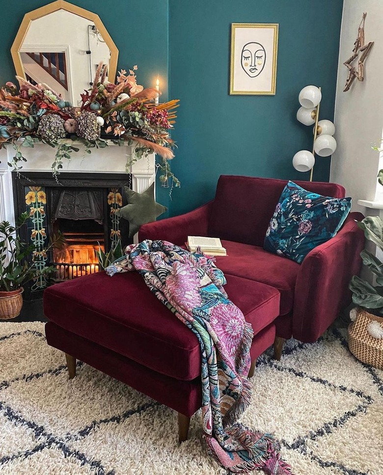 The corner of a living room with teal walls