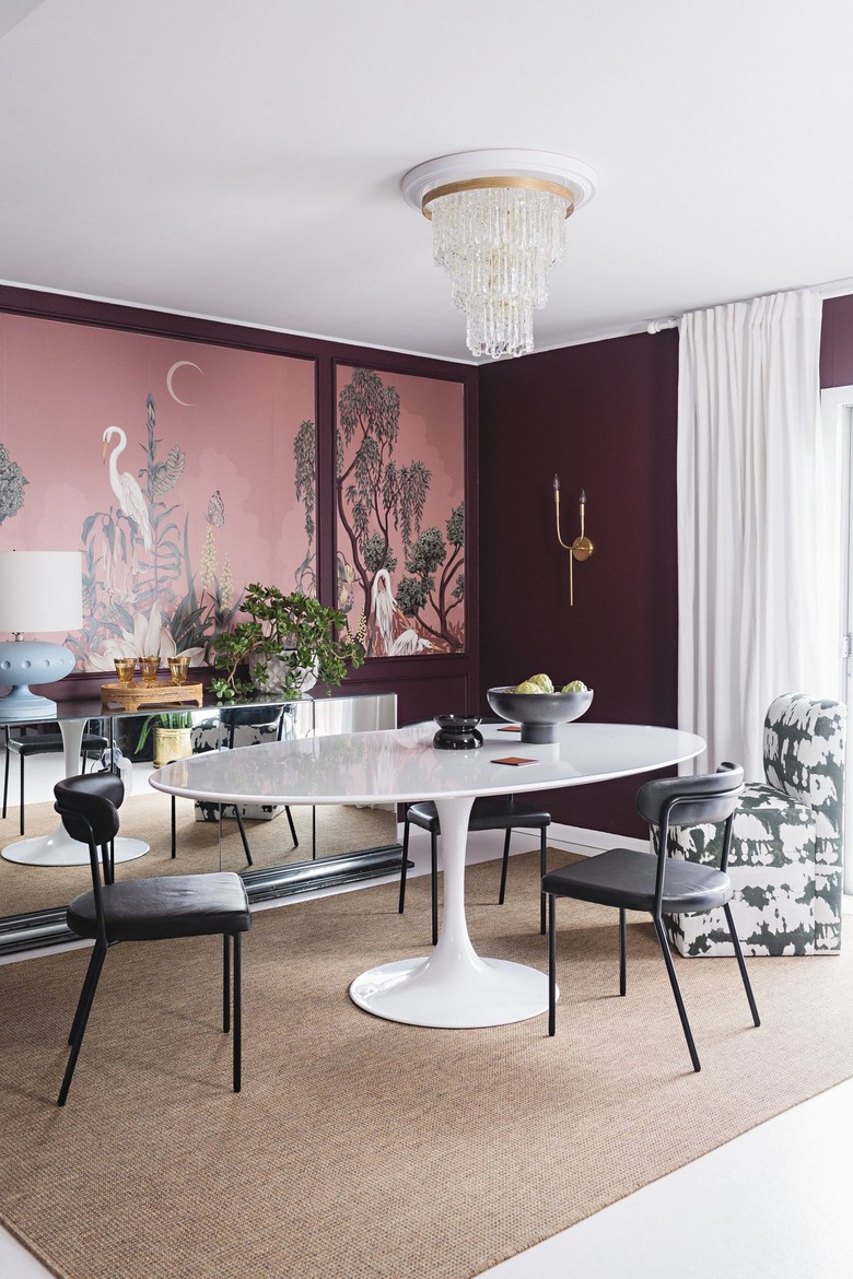 A dining room with pink wall art