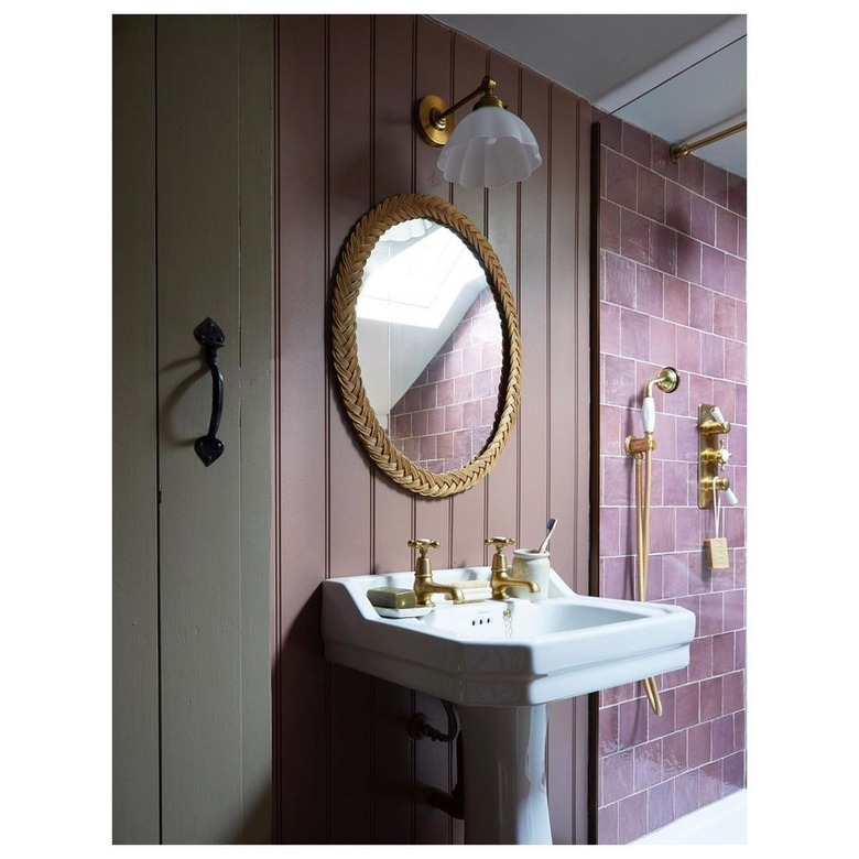 A bathroom with plum walls