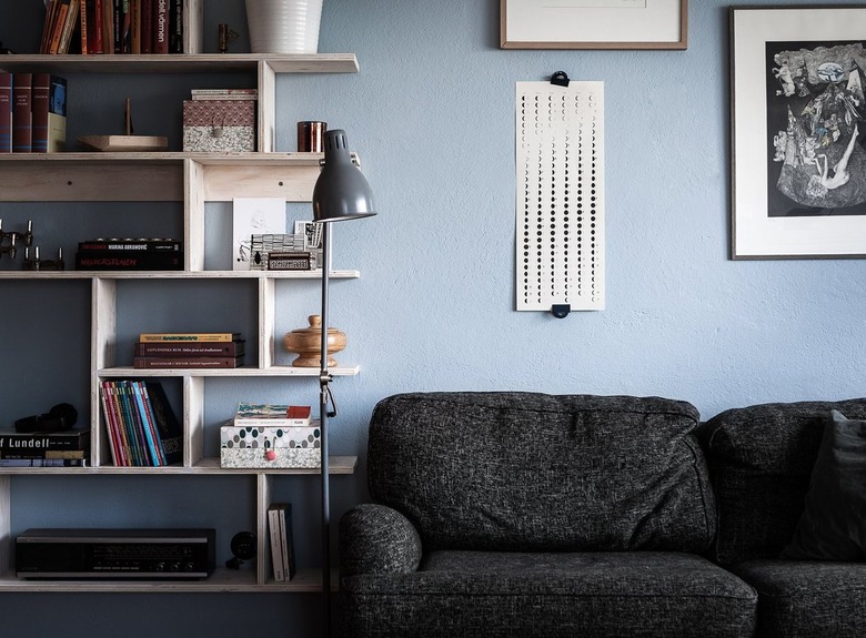 blue living room with black sofa