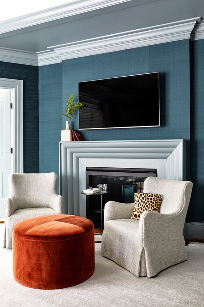blue sitting area with burnt orange ottoman