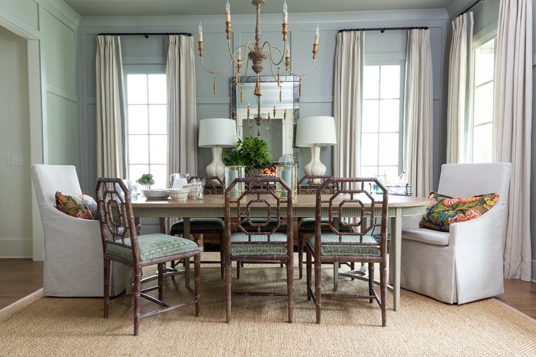 Dining room with green-blue walls and brown area rug