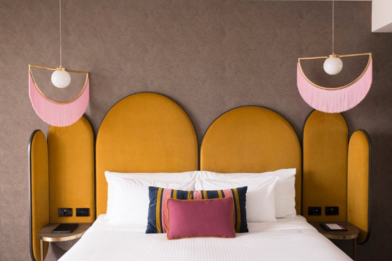 mustard yellow headboard in brown room