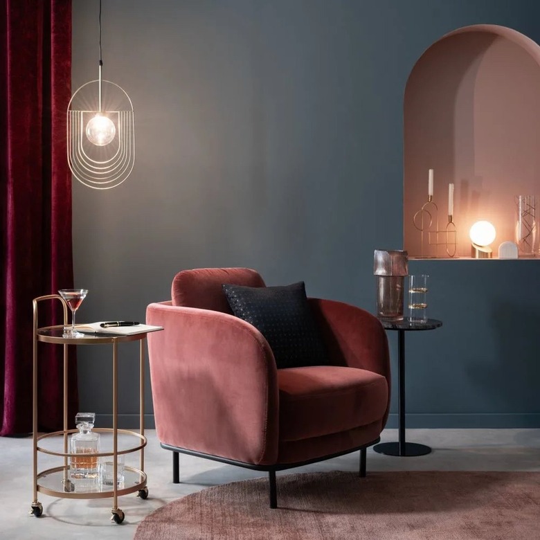 charcoal gray seating area with burgundy drapery and chair