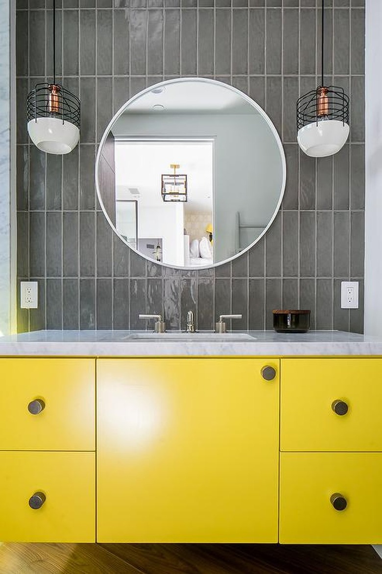Yellow vanity and charcoal gray backsplash