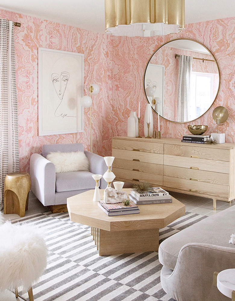 A boho glam bedroom with pink marble wallpaper