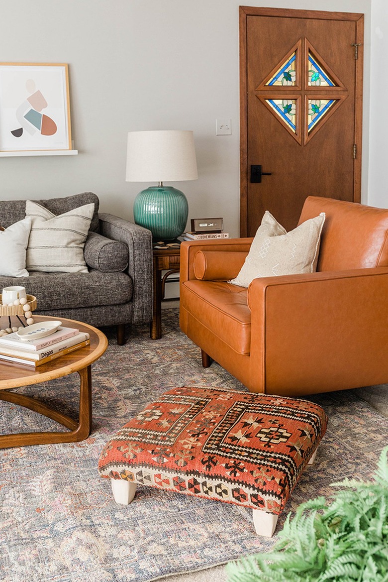 Vintage rug ottoman in a living room with a brown and gray theme