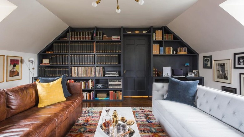 A reading room with mismatched brown leather sofa and gray sofa