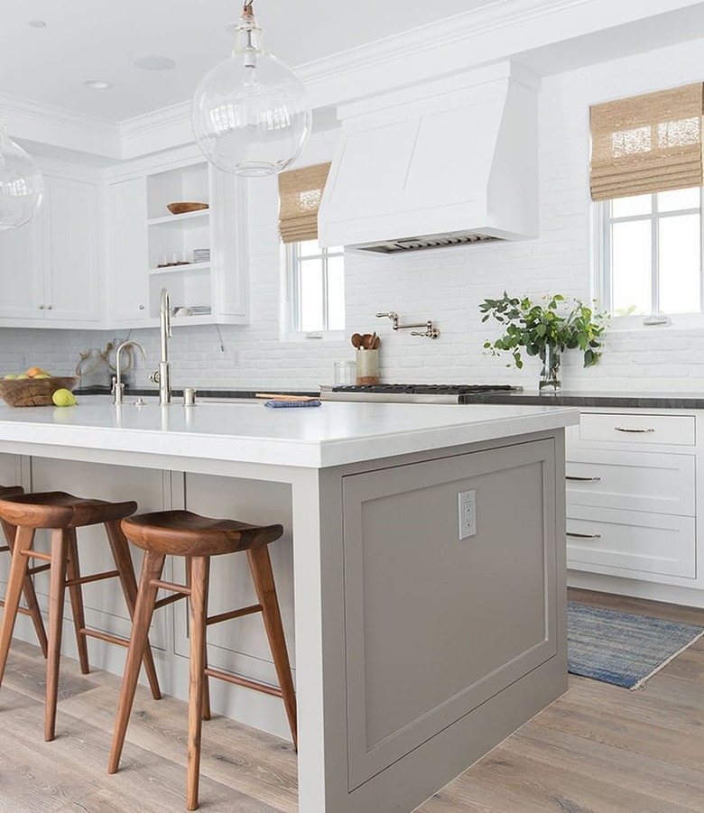 A bright white kitchen with greige island
