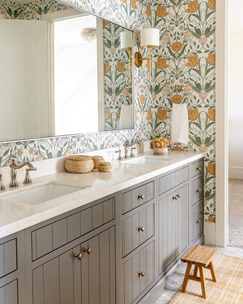 A bathroom with mustard and green floral wallpaper