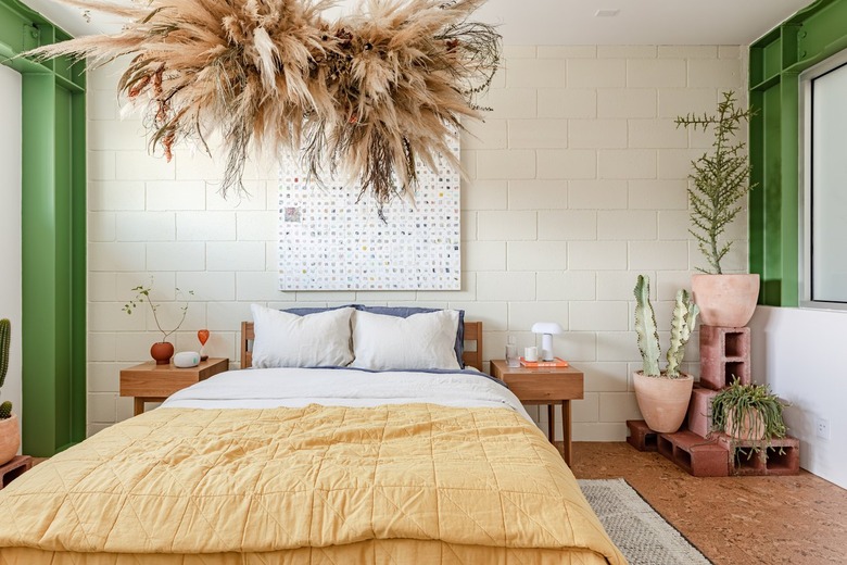 bedroom with green walls and yellow bedspread
