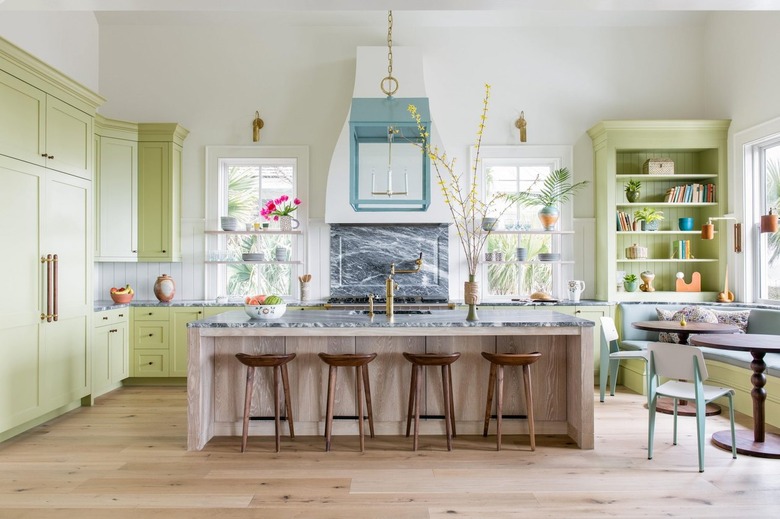 pastel kitchen with yellow green cabinets and blue pendant