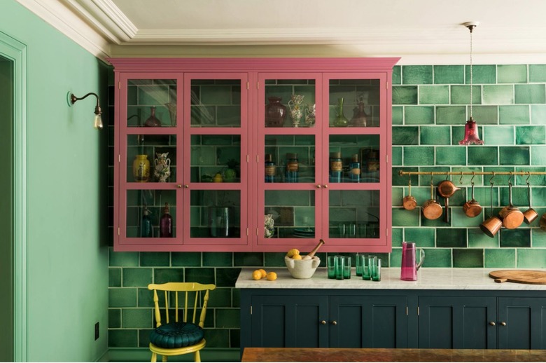 kitchen with green walls and pink cabinetry