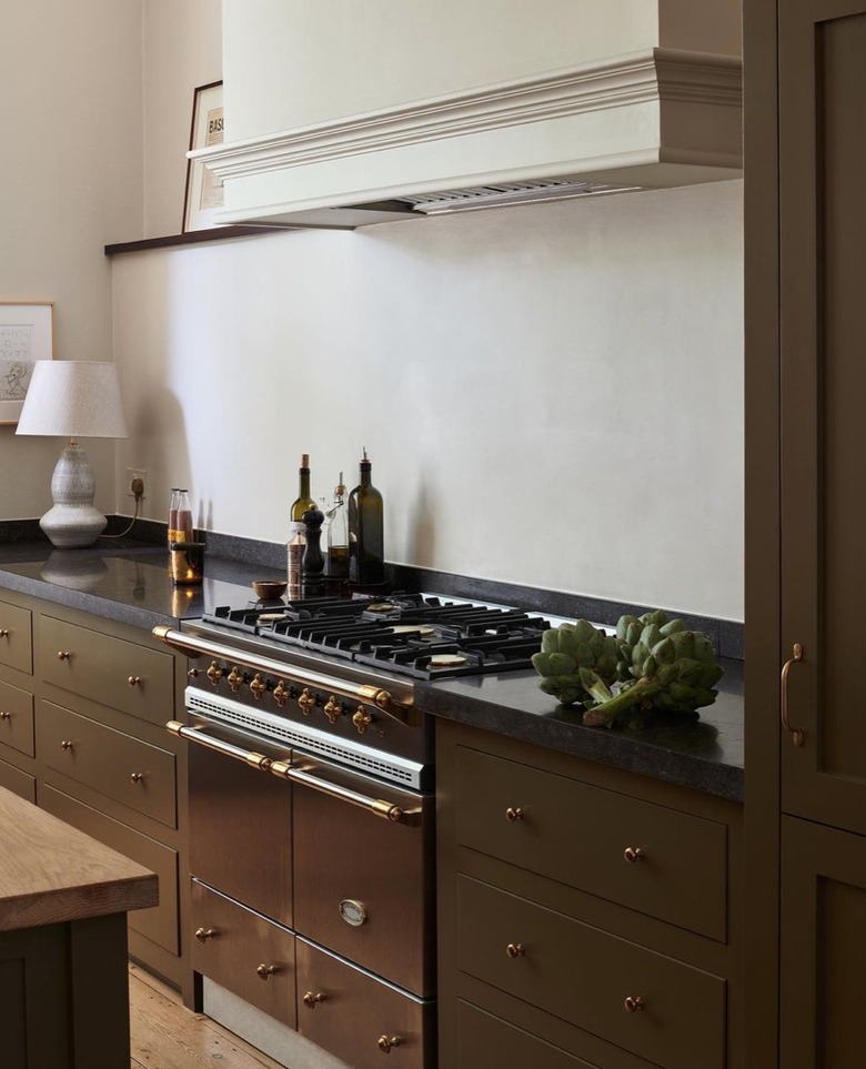 kitchen with muddy green cabinets and creamy texturized walls