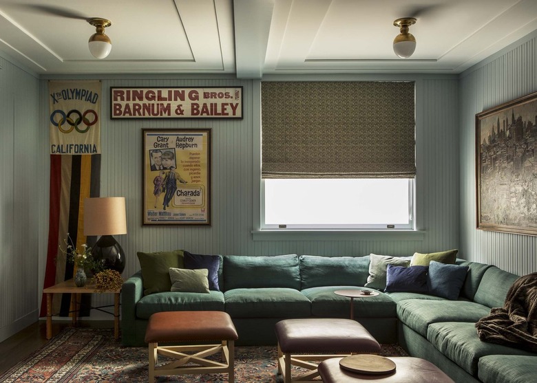 comfy TV room with cool blue walls and large green sectional
