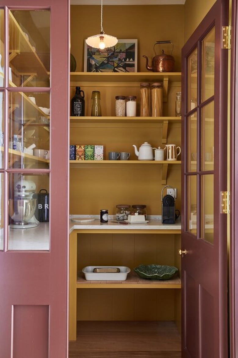 Pantry with maroon doors and yellow interior.
